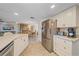Bright kitchen with stainless steel appliances, white cabinetry, and a view into the dining area at 1003 N Gondola Dr, Venice, FL 34293