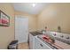 Functional laundry room with neutral walls, tile flooring, a washing machine, and a dryer at 1003 N Gondola Dr, Venice, FL 34293
