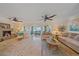 Spacious living area with tile floors, comfortable seating, a fireplace, and seamless access to other rooms, creating an inviting space at 1003 N Gondola Dr, Venice, FL 34293