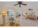 Cozy living room with elegant archways, comfortable seating, tile floors, and a view to other rooms at 1003 N Gondola Dr, Venice, FL 34293