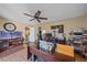 Office features a large desk, ample lighting, neutral walls, wood-look floors, and a ceiling fan at 1003 N Gondola Dr, Venice, FL 34293