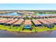 Aerial view of the property, surrounded by lakes and lush greenery in a vibrant community at 10064 Cozy Grove Dr, Venice, FL 34293