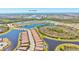 Scenic aerial view of community homes with pond and landscape, near to Gulf of America at 10064 Cozy Grove Dr, Venice, FL 34293