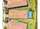 Aerial view of the property showcasing its tile roof and screened-in pool area at 10064 Cozy Grove Dr, Venice, FL 34293