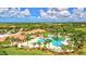 A stunning aerial view capturing the pool and clubhouse area at Sarasota National, surrounded by lush landscaping at 10064 Cozy Grove Dr, Venice, FL 34293