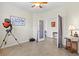 Neutral bedroom featuring tile floors, a telescope, and natural light from an open doorway at 10064 Cozy Grove Dr, Venice, FL 34293