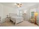 Bright bedroom features carpet, neutral walls, ceiling fan, and two windows with natural light at 10064 Cozy Grove Dr, Venice, FL 34293