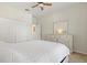 Light bedroom with carpet, neutral walls, and a white dresser with mirror above at 10064 Cozy Grove Dr, Venice, FL 34293