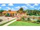 Welcoming community entrance featuring a gatehouse, stone waterfall feature, and lush landscaping at 10064 Cozy Grove Dr, Venice, FL 34293