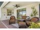 Outdoor covered patio with seating, ceiling fan, and brick flooring at 10064 Cozy Grove Dr, Venice, FL 34293