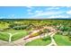 Entrance to gated community with lush landscaping and well manicured green lawn at 10064 Cozy Grove Dr, Venice, FL 34293
