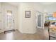 Bright foyer with tiled floors, a decorative glass front door, and a glimpse into the living area at 10064 Cozy Grove Dr, Venice, FL 34293
