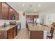 Kitchen with granite countertops, stainless steel appliances, a large island and an open floorplan at 10064 Cozy Grove Dr, Venice, FL 34293