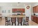 Kitchen with granite countertops, stainless steel appliances, and an island with bar seating at 10064 Cozy Grove Dr, Venice, FL 34293