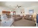 Spacious living room featuring comfortable couches, an open layout, and neutral decor at 10064 Cozy Grove Dr, Venice, FL 34293