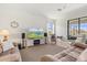 Cozy living room with a TV, neutral colors, comfortable seating and large windows for natural light at 10064 Cozy Grove Dr, Venice, FL 34293