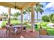 Covered patio with seating overlooking a scenic lake, perfect for outdoor dining and relaxation at 10064 Cozy Grove Dr, Venice, FL 34293
