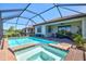 Inviting screened pool and spa area with brick pavers and comfortable patio seating at 10064 Cozy Grove Dr, Venice, FL 34293