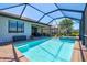 Beautiful screened pool area with sparkling water and brick-paved patio at 10064 Cozy Grove Dr, Venice, FL 34293