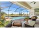 Enclosed pool with spa, brick pavers, and beautiful lake view in backyard at 10064 Cozy Grove Dr, Venice, FL 34293