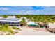 Beachfront restaurant with vibrant umbrellas, tropical palms, and outdoor seating at 10064 Cozy Grove Dr, Venice, FL 34293