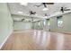 Bright dance studio with wood floor, full mirror wall, and natural light at 10064 Cozy Grove Dr, Venice, FL 34293