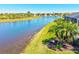 View from the side of the property highlighting lush landscaping and pristine water views at 10064 Cozy Grove Dr, Venice, FL 34293