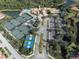 Aerial view of the community clubhouse, tennis courts, and resort style pool at 101 Portofino Dr, North Venice, FL 34275