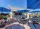 Outdoor bar and seating area with blue umbrellas at 101 Portofino Dr, North Venice, FL 34275