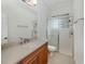 Bathroom featuring a single sink vanity, tile floors, and glass enclosed shower at 101 Portofino Dr, North Venice, FL 34275