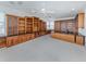 Spacious bonus room with carpet, a ceiling fan, built in bookshelves, and granite countertops at 101 Portofino Dr, North Venice, FL 34275