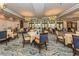 Elegant dining room featuring chandeliers, seating and large windows offering natural light at 101 Portofino Dr, North Venice, FL 34275