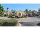 Beautiful Tuscan-style clubhouse with manicured landscaping and circular driveway at 101 Portofino Dr, North Venice, FL 34275