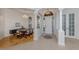 Grand foyer featuring elegant tile flooring, decorative columns, and a dining area at 101 Portofino Dr, North Venice, FL 34275