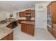 Well-appointed kitchen boasts modern appliances, granite counters, and functional center island at 101 Portofino Dr, North Venice, FL 34275