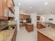 Modern kitchen with stainless steel appliances, granite countertops, and custom cabinetry at 101 Portofino Dr, North Venice, FL 34275