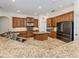 Spacious kitchen with granite counters, ample cabinet space, and stainless steel appliances at 101 Portofino Dr, North Venice, FL 34275