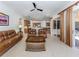 Inviting living room with tile flooring and seamless transition to modern kitchen at 101 Portofino Dr, North Venice, FL 34275