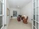 Bright office space with French doors, ceiling fan, and comfortable furnishings at 101 Portofino Dr, North Venice, FL 34275