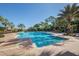 Spacious community pool and spa surrounded by palm trees and lounge chairs at 101 Portofino Dr, North Venice, FL 34275