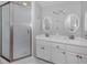 Bathroom featuring a glass-enclosed shower, dual vanities, and contemporary fixtures at 1041 Capri Isles Blvd # 224, Venice, FL 34292
