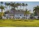 Charming single-story home featuring a well-maintained yard, a white picket fence and lush landscaping, offering comfort and style at 1041 Capri Isles Blvd # 224, Venice, FL 34292