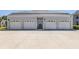 A multi-car garage with concrete driveway offers plenty of parking at 1041 Capri Isles Blvd # 224, Venice, FL 34292