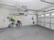 Spacious garage with an automatic door, ceiling fan, and plenty of wall storage at 1041 Capri Isles Blvd # 224, Venice, FL 34292