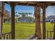 View from gazebo overlooking well-manicured lawn and beautiful palm trees, creating a tranquil and inviting setting at 1041 Capri Isles Blvd # 224, Venice, FL 34292