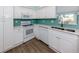 Kitchen features stainless steel appliances, tile backsplash, and double sink at 1041 Capri Isles Blvd # 224, Venice, FL 34292