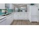 Kitchen with stainless steel appliances, light blue tile backsplash and an eat-in kitchen area at 1041 Capri Isles Blvd # 224, Venice, FL 34292