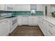 Kitchen boasts stainless steel appliances, tile backsplash and ample white cabinets at 1041 Capri Isles Blvd # 224, Venice, FL 34292
