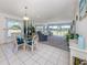 Open living and dining area with large windows and view at 1041 Capri Isles Blvd # 224, Venice, FL 34292