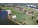 Overhead view of a beautiful golf course featuring a green, sand traps, and ponds, amidst lush landscaping at 109 Southampton N Pl # 245, Venice, FL 34293